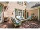 Back porch with wooden chairs and patio furniture with a view of the yard at 225 Ansley Close, Roswell, GA 30075