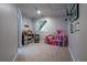 Finished basement area perfect as a playroom with carpeted floors and a small window at 225 Ansley Close, Roswell, GA 30075