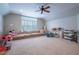 Spacious basement playroom with plush carpeting, a large window, and comfortable seating at 225 Ansley Close, Roswell, GA 30075