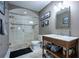 Bathroom featuring walk-in tiled shower and a wooden vanity with a marble countertop at 225 Ansley Close, Roswell, GA 30075