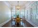 Cozy breakfast nook featuring plantation shutters, a modern light fixture, and hardwood flooring at 225 Ansley Close, Roswell, GA 30075