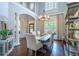 Formal dining room featuring tall ceilings, hardwood floors, and a wooden table set for six at 225 Ansley Close, Roswell, GA 30075