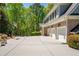 Long driveway with a basketball hoop leading to a three car garage at 225 Ansley Close, Roswell, GA 30075