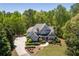 Beautiful two-story home with well-manicured landscaping, a large driveway, and a welcoming front porch at 225 Ansley Close, Roswell, GA 30075
