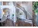 Grand foyer with high ceilings, hardwood floors, a staircase, and elegant columns at 225 Ansley Close, Roswell, GA 30075