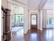 Elegant foyer with hardwood floors, columns, and a stained glass front door at 225 Ansley Close, Roswell, GA 30075