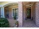 Charming brick front porch with a wooden door and decorative wreath at 225 Ansley Close, Roswell, GA 30075