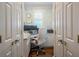 Compact home office space with built-in desk, storage, and stylish wallpaper at 225 Ansley Close, Roswell, GA 30075