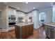 Well-lit kitchen with a central island, stainless steel appliances, and hardwood flooring at 225 Ansley Close, Roswell, GA 30075