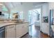 Open kitchen featuring a sink, stainless steel refrigerator, hardwood floors, and backyard views at 225 Ansley Close, Roswell, GA 30075