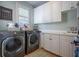 Well-appointed laundry room featuring modern appliances and ample storage space at 225 Ansley Close, Roswell, GA 30075
