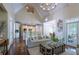 Open-concept living room featuring high ceilings, wood floors, and views into the kitchen, breakfast nook, and backyard at 225 Ansley Close, Roswell, GA 30075