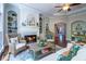 Cozy living room featuring a fireplace, built-in shelving, hardwood floors, and comfortable seating at 225 Ansley Close, Roswell, GA 30075