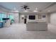 Spacious living area with a ceiling fan and a couch facing a wall-mounted television at 225 Ansley Close, Roswell, GA 30075
