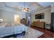 Spacious main bedroom with wood floors, a tray ceiling, and access to an ensuite bathroom at 225 Ansley Close, Roswell, GA 30075