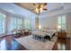 Cozy main bedroom featuring large windows, hardwood floors, and tray ceiling at 225 Ansley Close, Roswell, GA 30075