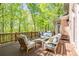 Exterior shot of an outdoor seating area with a grill overlooking the backyard at 225 Ansley Close, Roswell, GA 30075