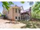 Expansive brick home with a screened porch and a deck overlooking the lush, green backyard at 225 Ansley Close, Roswell, GA 30075