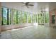 Screened porch with tile floor and view to the wooded backyard at 225 Ansley Close, Roswell, GA 30075