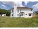 Rear view of a two-story home with a large backyard and well-maintained lawn at 3019 Havenwood Way, Stonecrest, GA 30038