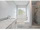 Bathroom featuring a soaking tub, double vanity and tiled shower at 3019 Havenwood Way, Stonecrest, GA 30038