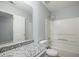 Bright bathroom with granite countertop, shower-tub combo, and a large mirror at 3019 Havenwood Way, Stonecrest, GA 30038