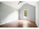 Bright bedroom with vaulted ceiling, hardwood floors, and a large arched window at 3019 Havenwood Way, Stonecrest, GA 30038