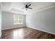 Bedroom with hardwood floors, ceiling fan, and large window providing natural light at 3019 Havenwood Way, Stonecrest, GA 30038