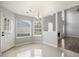 Dining area with white tile flooring, open to living room and access to the exterior at 3019 Havenwood Way, Stonecrest, GA 30038
