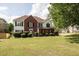 Charming two-story home with brick and siding, a green lawn and mature trees at 3019 Havenwood Way, Stonecrest, GA 30038