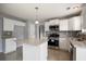 Well-lit kitchen boasting an island, stainless steel appliances and gray tile backsplash at 3019 Havenwood Way, Stonecrest, GA 30038