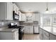 Bright kitchen with white cabinetry, granite countertops and modern stainless appliances at 3019 Havenwood Way, Stonecrest, GA 30038