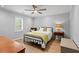 Traditional bedroom with wood floor, ceiling fan, and neutral color palette at 3570 W Hampton Nw Dr, Marietta, GA 30064