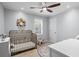 Cozy bedroom featuring a white crib, and floral decor at 3570 W Hampton Nw Dr, Marietta, GA 30064