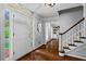 Bright foyer with hardwood floors, white trim, and a staircase with carpeted steps at 3570 W Hampton Nw Dr, Marietta, GA 30064