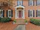 Traditional brick home featuring a covered front entry with columns and a meticulously landscaped yard at 3570 W Hampton Nw Dr, Marietta, GA 30064