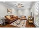 Inviting living room with hardwood floors, a ceiling fan, and a comfortable leather couch at 3570 W Hampton Nw Dr, Marietta, GA 30064