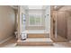 Relaxing bathroom with soaking tub, glass-enclosed shower, and natural light offers a spa-like experience at 3570 W Hampton Nw Dr, Marietta, GA 30064