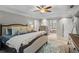 Spacious primary bedroom with tray ceiling, hardwood furnishings, and a carpeted floor with ensuite at 3570 W Hampton Nw Dr, Marietta, GA 30064