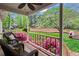 Cozy porch with wicker chairs, a floral rug and bright pink flowers at 3570 W Hampton Nw Dr, Marietta, GA 30064