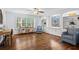 Cozy sitting room featuring hardwood floors, built-in bookshelves, and comfortable seating by the window at 3570 W Hampton Nw Dr, Marietta, GA 30064