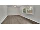 Inviting bedroom with new flooring, neutral walls, ceiling fan, and bright windows overlooking the backyard at 3983 E Hilda Cir, Decatur, GA 30035