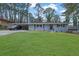 Beautiful home with blue painted brick, a spacious front lawn, and covered carport, perfect for suburban living at 3983 E Hilda Cir, Decatur, GA 30035