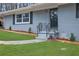 Charming brick home featuring a black wrought iron railing, fresh landscaping, and newly sodded lawn at 3983 E Hilda Cir, Decatur, GA 30035