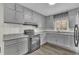 Modern gray kitchen with ample cabinetry, granite countertops, and stainless steel appliances providing functionality and style at 3983 E Hilda Cir, Decatur, GA 30035