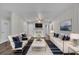 Stylishly decorated living room with a white brick fireplace, plush seating, and modern decor at 3983 E Hilda Cir, Decatur, GA 30035