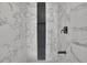 Contemporary shower with marble-like tiles and a sleek black shower head at 3983 E Hilda Cir, Decatur, GA 30035