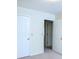Bright bedroom with neutral carpet and white trim, leading to additional room at 746 Oak Terrace Ter, Norcross, GA 30071