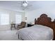 Spacious bedroom with a ceiling fan, and a classic wood headboard at 746 Oak Terrace Ter, Norcross, GA 30071