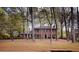 Classic brick home with mature trees offering shade and curb appeal at 746 Oak Terrace Ter, Norcross, GA 30071
